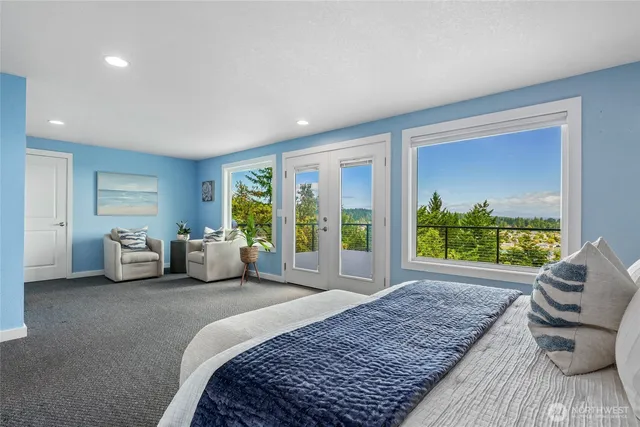 a spacious bedroom with a large bed and a large window