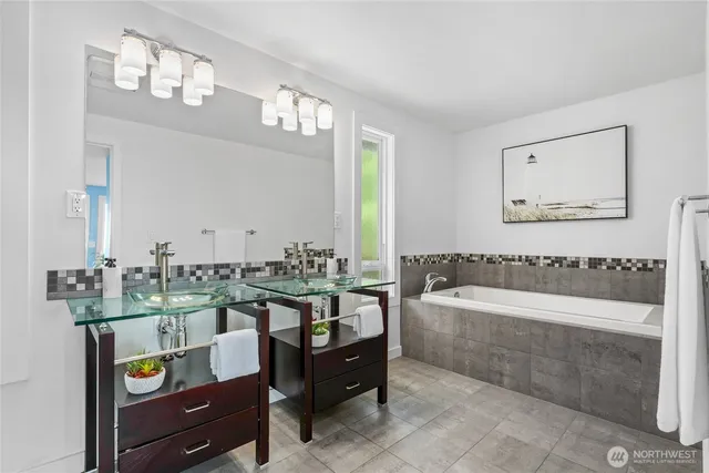 a spacious bathroom with a tub and sink