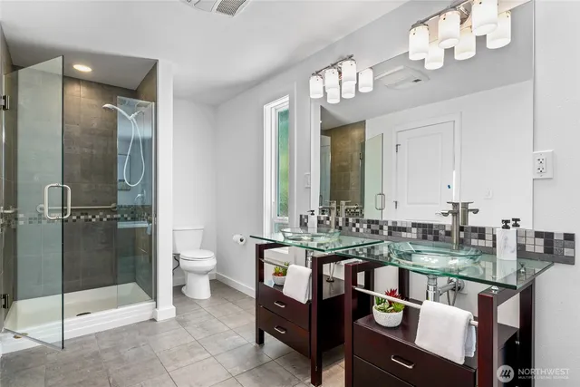 a very nice looking dining room with a large mirror and a chandelier