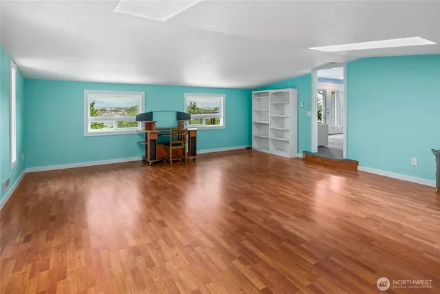 a view of a livingroom with furniture and a hardwood floor