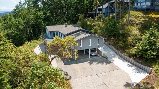 a view of a house with pool and sitting area