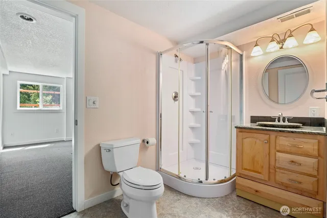 a bathroom with a granite countertop toilet sink and shower