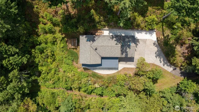 an aerial view of a house with pool