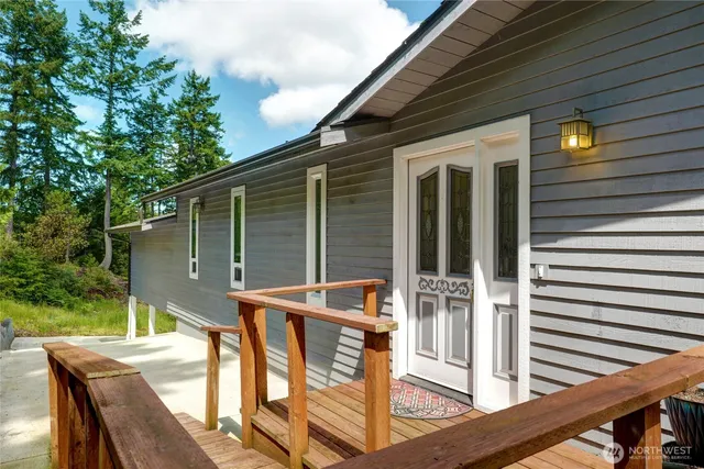 a view of backyard with deck and outdoor seating