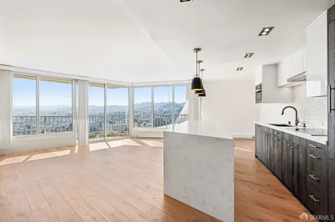 a view of kitchen with sink and wooden floor