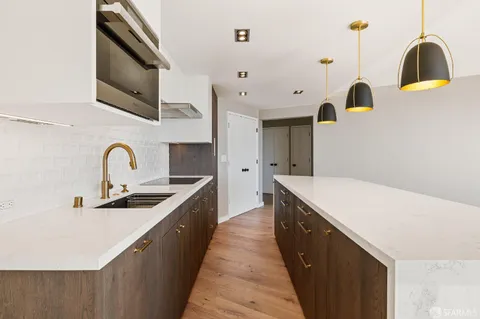 a kitchen with a sink and a stove