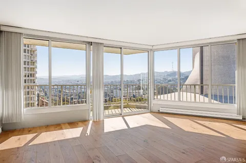 a view of wooden floor and windows in a room