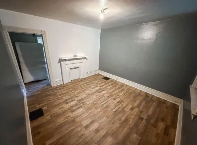 a view of a hallway to room with wooden floor and stair