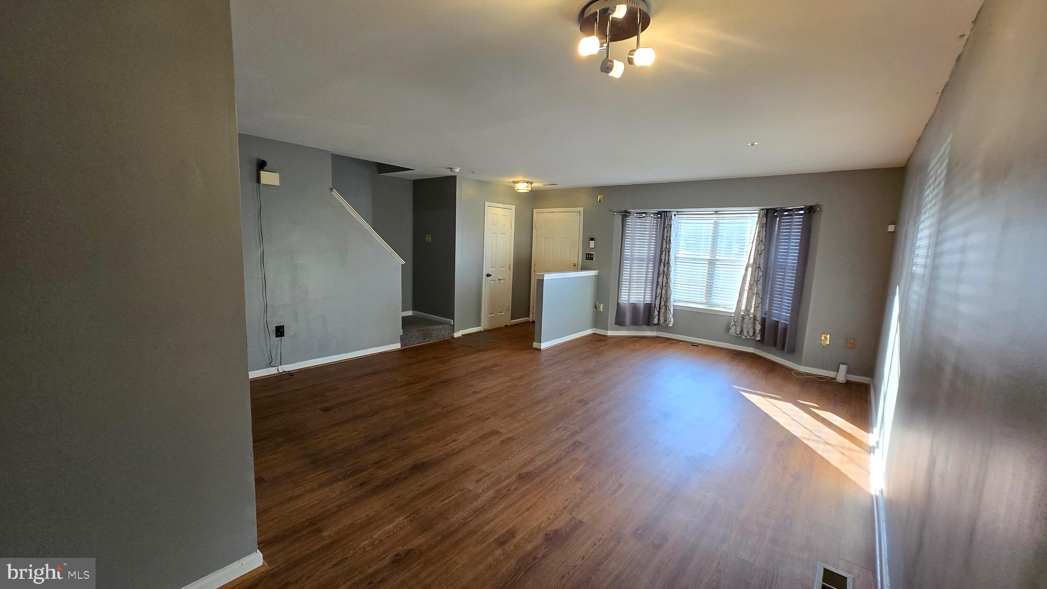6565 Ronald Road Capitol Heights, MD 20743 - Photo 4 of 20 an empty room with wooden floor and windows
