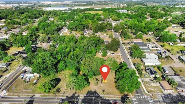 an aerial view of residential houses with outdoor space and street view