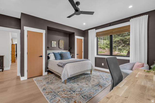 1766 West Tollgate Cyn Road Coalville, UT 84017 - Photo 14 of 59 Bedroom featuring a large window with a natural landscape backdrop, light wood-finish flooring, and a modern ceiling fan