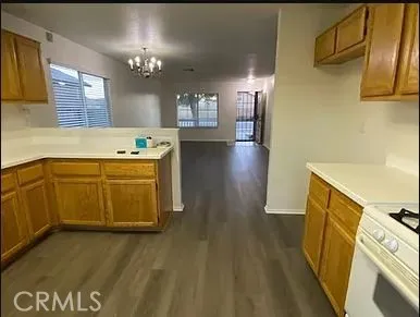 a view of a kitchen with a sink cabinets and wooden floor