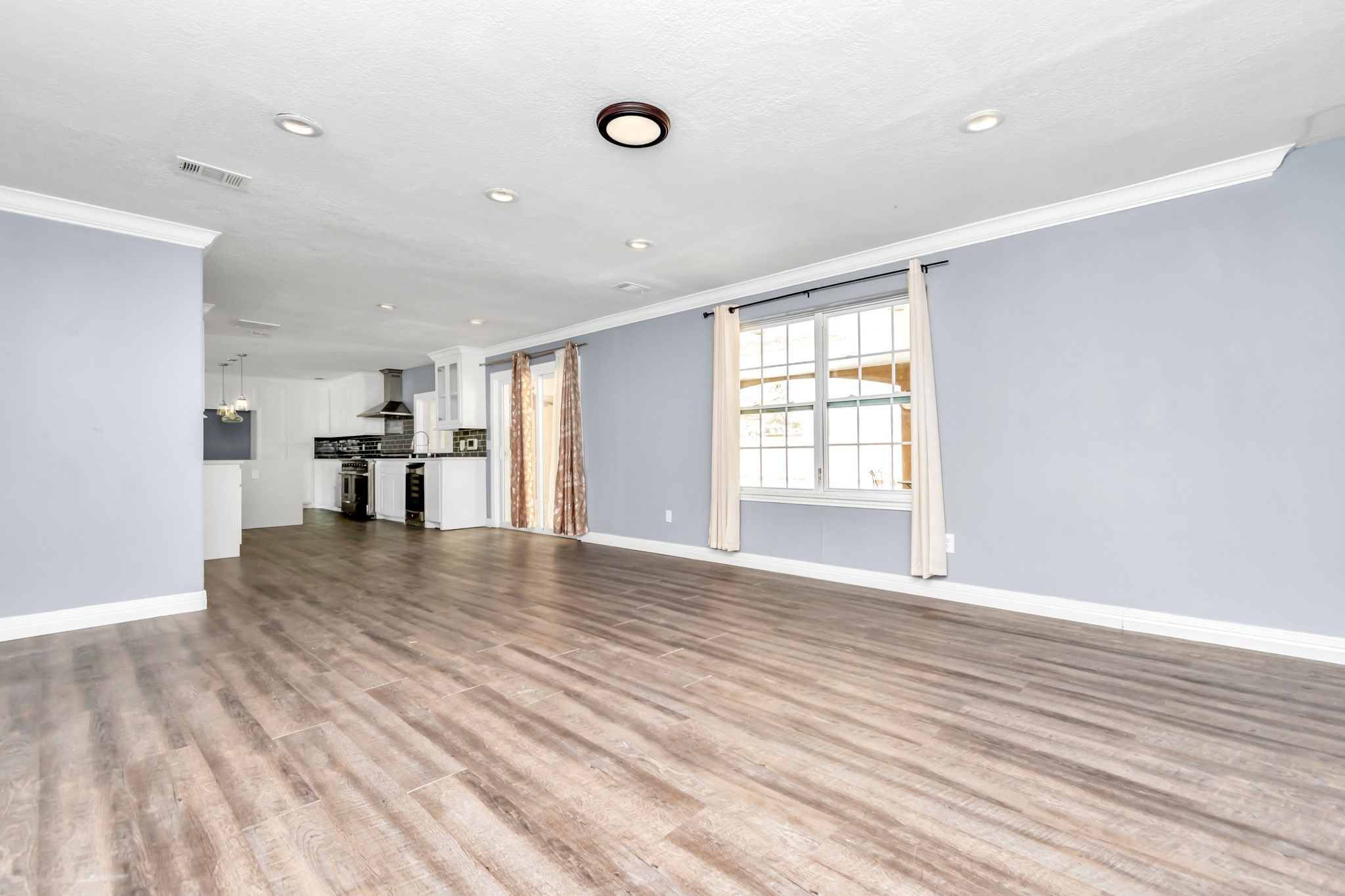 12418 Mill Ridge Drive Cypress, TX 77429 - Photo 12 of 36 a view of empty room with wooden floor and windows
