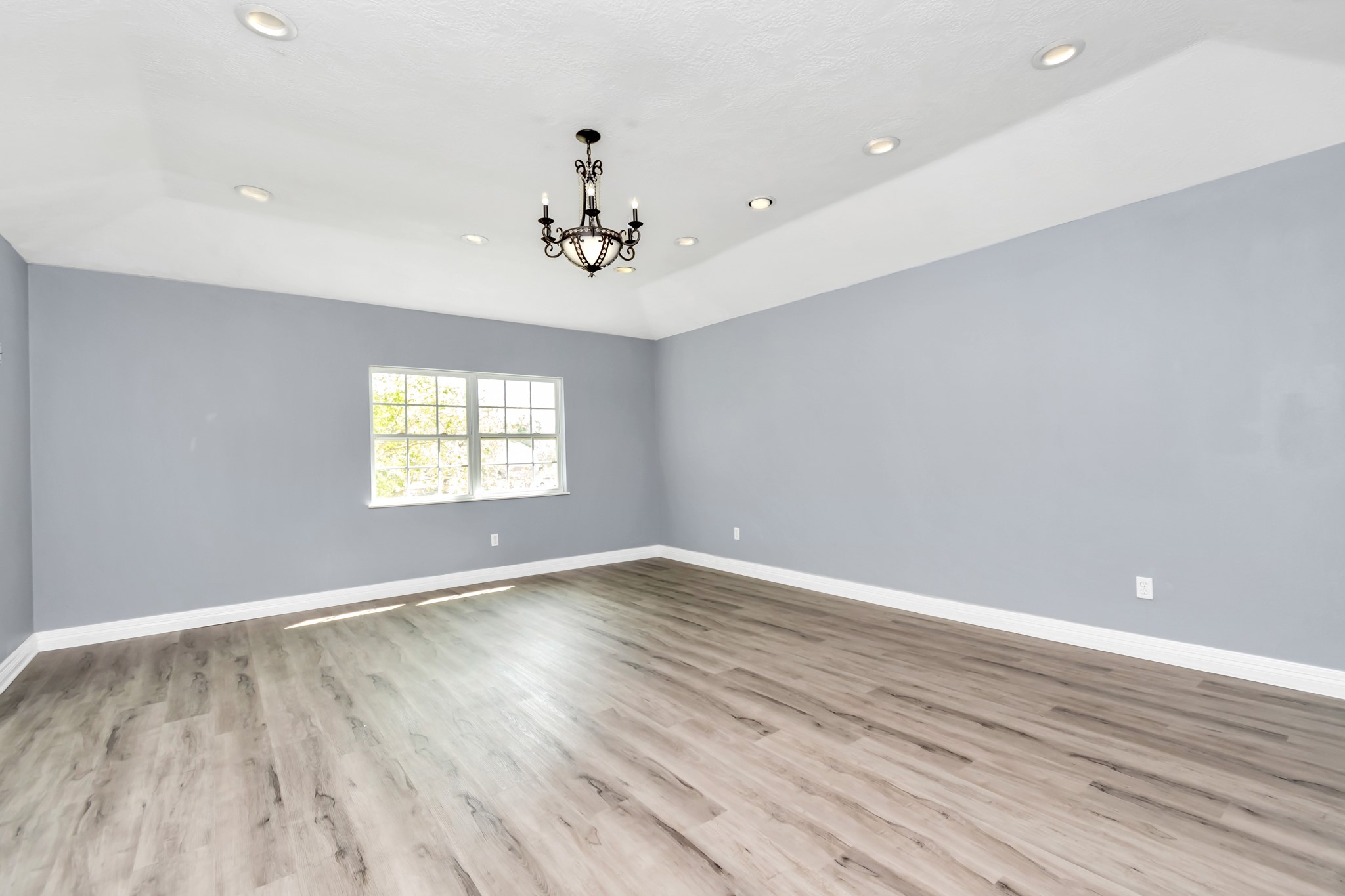 12418 Mill Ridge Drive Cypress, TX 77429 - Photo 14 of 36 an empty room with wooden floor and windows