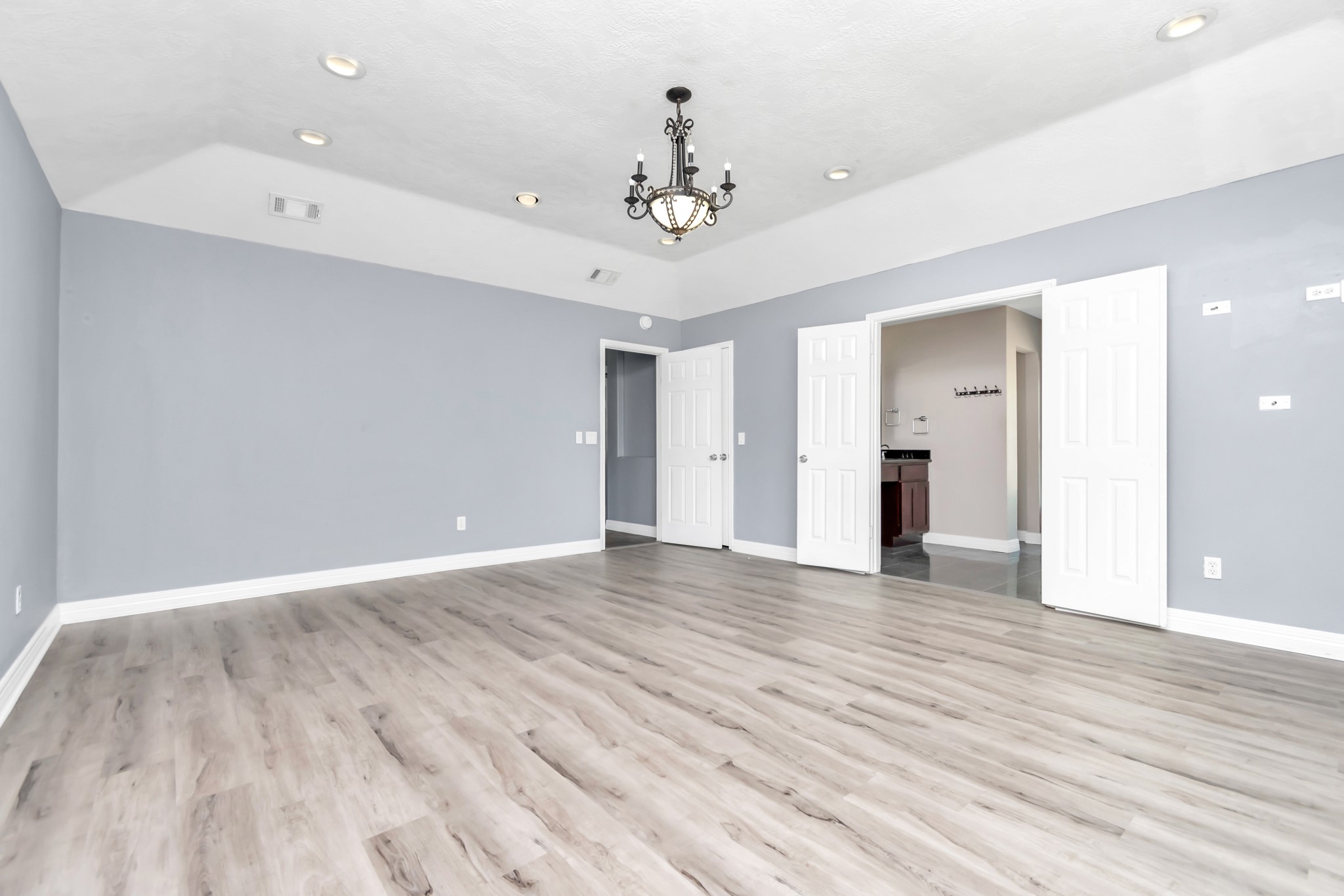 12418 Mill Ridge Drive Cypress, TX 77429 - Photo 16 of 36 a view of an empty room with wooden floor and a ceiling fan