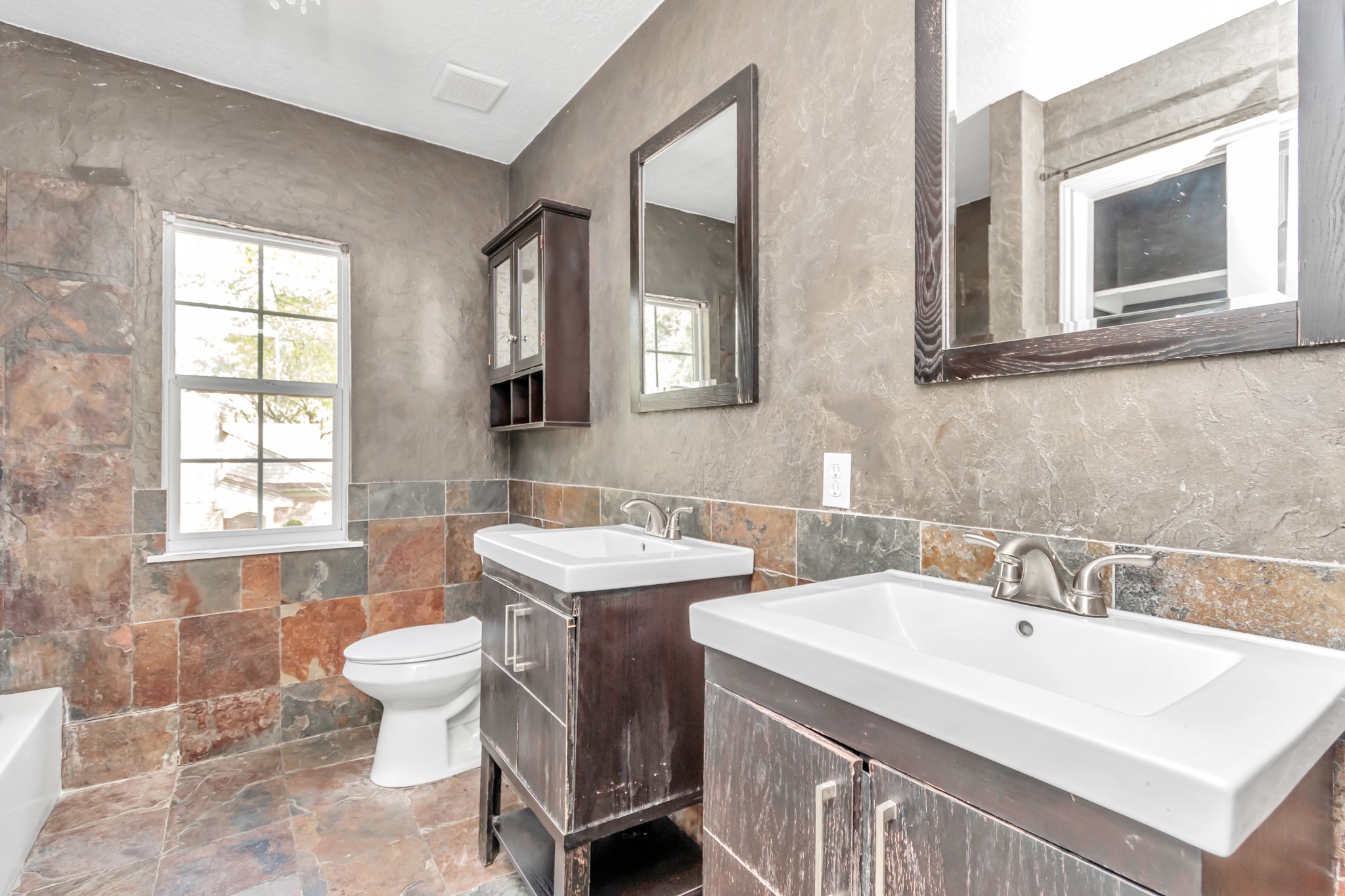 12418 Mill Ridge Drive Cypress, TX 77429 - Photo 21 of 36 a bathroom with 2 sink and a mirror
