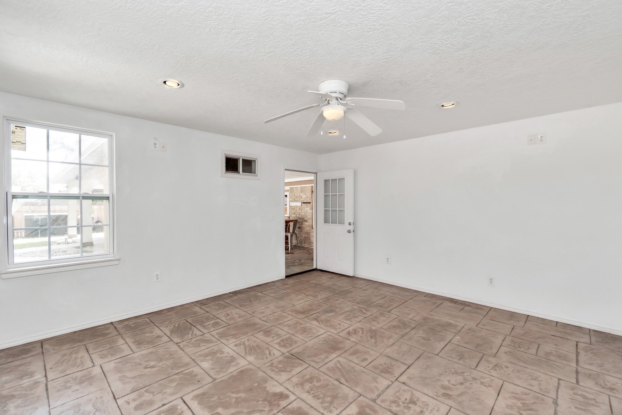 12418 Mill Ridge Drive Cypress, TX 77429 - Photo 28 of 36 an empty room with windows and ceiling fan