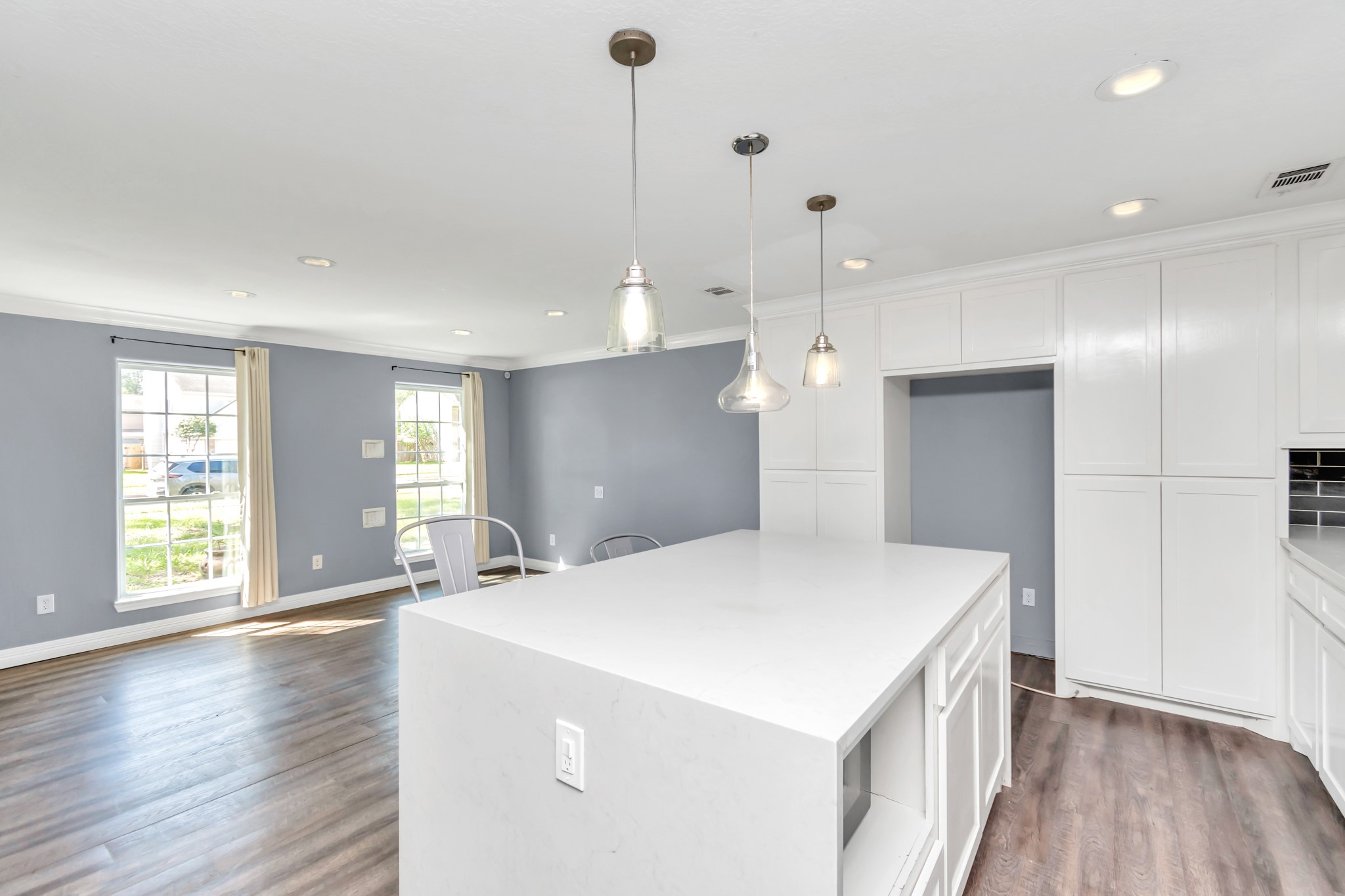 12418 Mill Ridge Drive Cypress, TX 77429 - Photo 6 of 36 a kitchen with kitchen island a sink appliances wooden floor and a window
