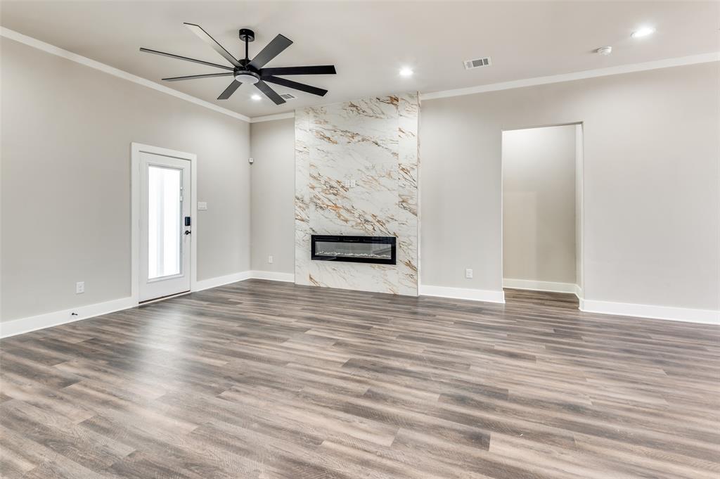 4113 Metropolitan Avenue Dallas, TX 75210 - Photo 11 of 30 a view of a livingroom with wooden floor and a ceiling fan