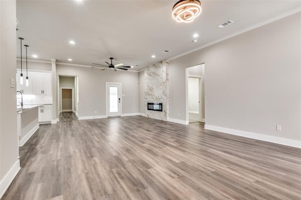4113 Metropolitan Avenue Dallas, TX 75210 - Photo 14 of 30 a view of an empty room and kitchen with furniture wooden floor
