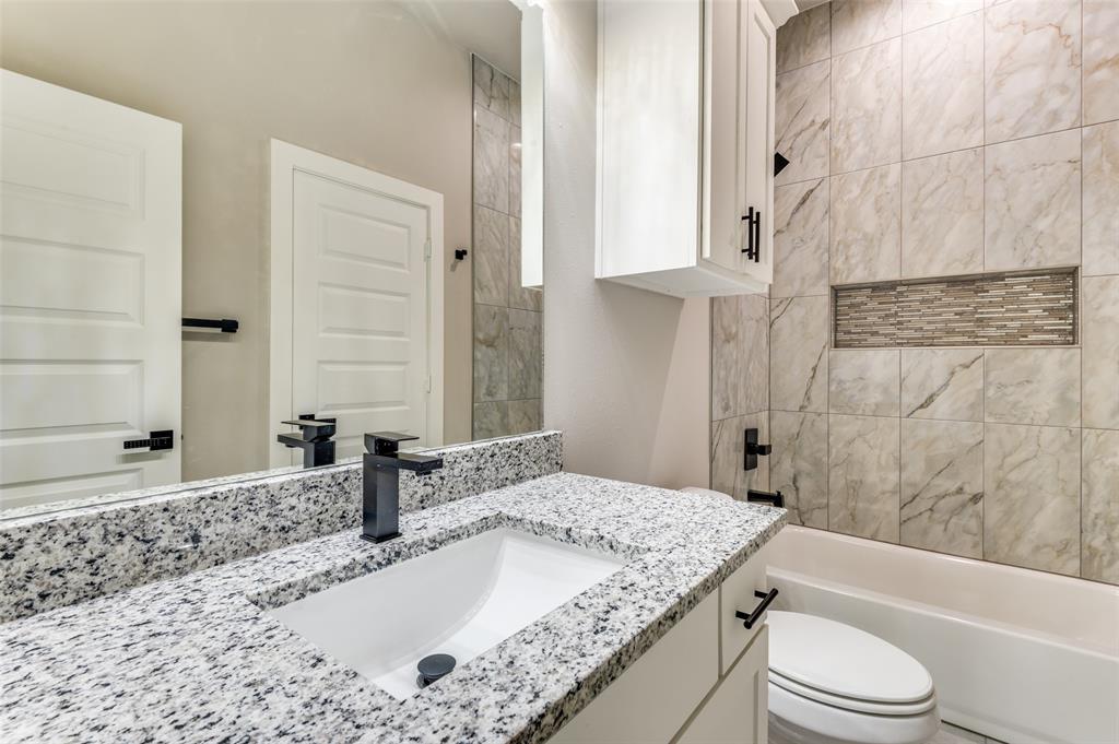 4113 Metropolitan Avenue Dallas, TX 75210 - Photo 19 of 30 a bathroom with a granite countertop sink toilet and shower