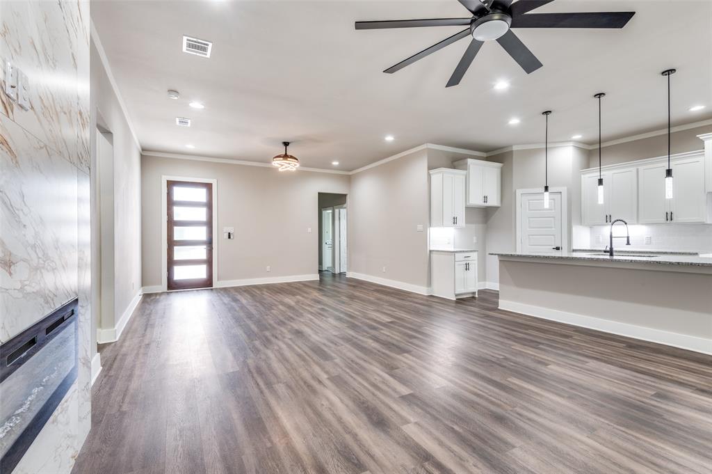 4113 Metropolitan Avenue Dallas, TX 75210 - Photo 4 of 30 a view of an empty room and kitchen with wooden floor