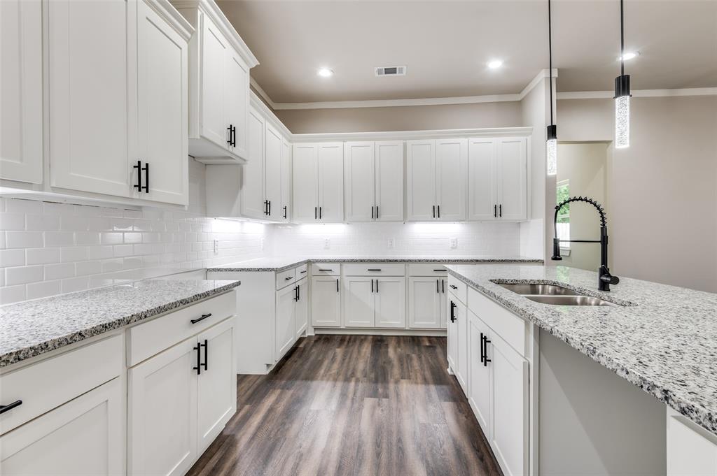 4113 Metropolitan Avenue Dallas, TX 75210 - Photo 9 of 30 a kitchen with granite countertop white cabinets and white appliances