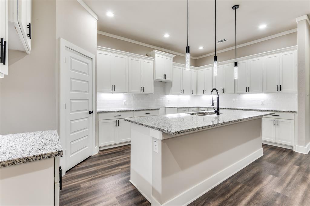 4113 Metropolitan Avenue Dallas, TX 75210 - Photo 10 of 30 a kitchen with stainless steel appliances granite countertop a sink a stove and a refrigerator