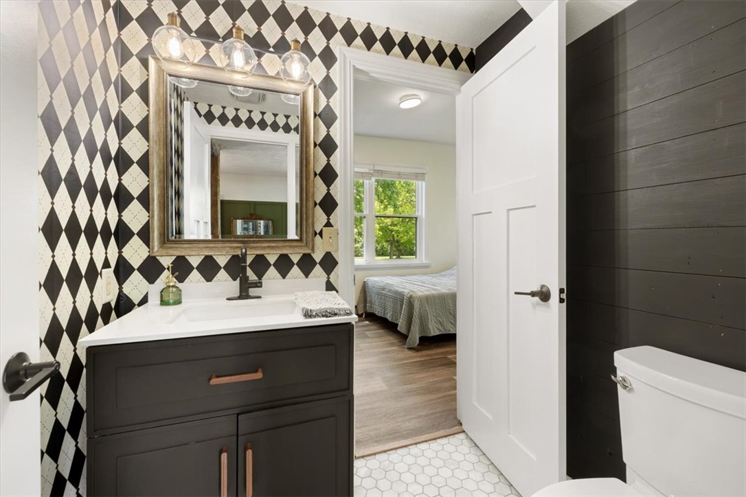5120 Wheelock Road Troy, OH 45373 - Photo 12 of 67 This bathroom features a contemporary vanity and stylish black and white diamond-patterned walls.