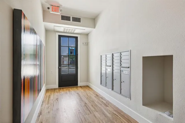 a view of hallway with wooden floor