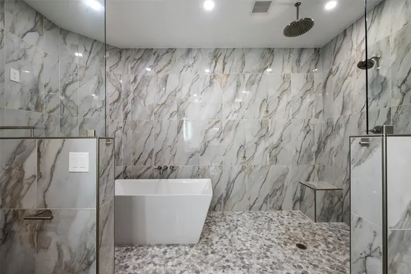 a bathroom with a bathtub and shower