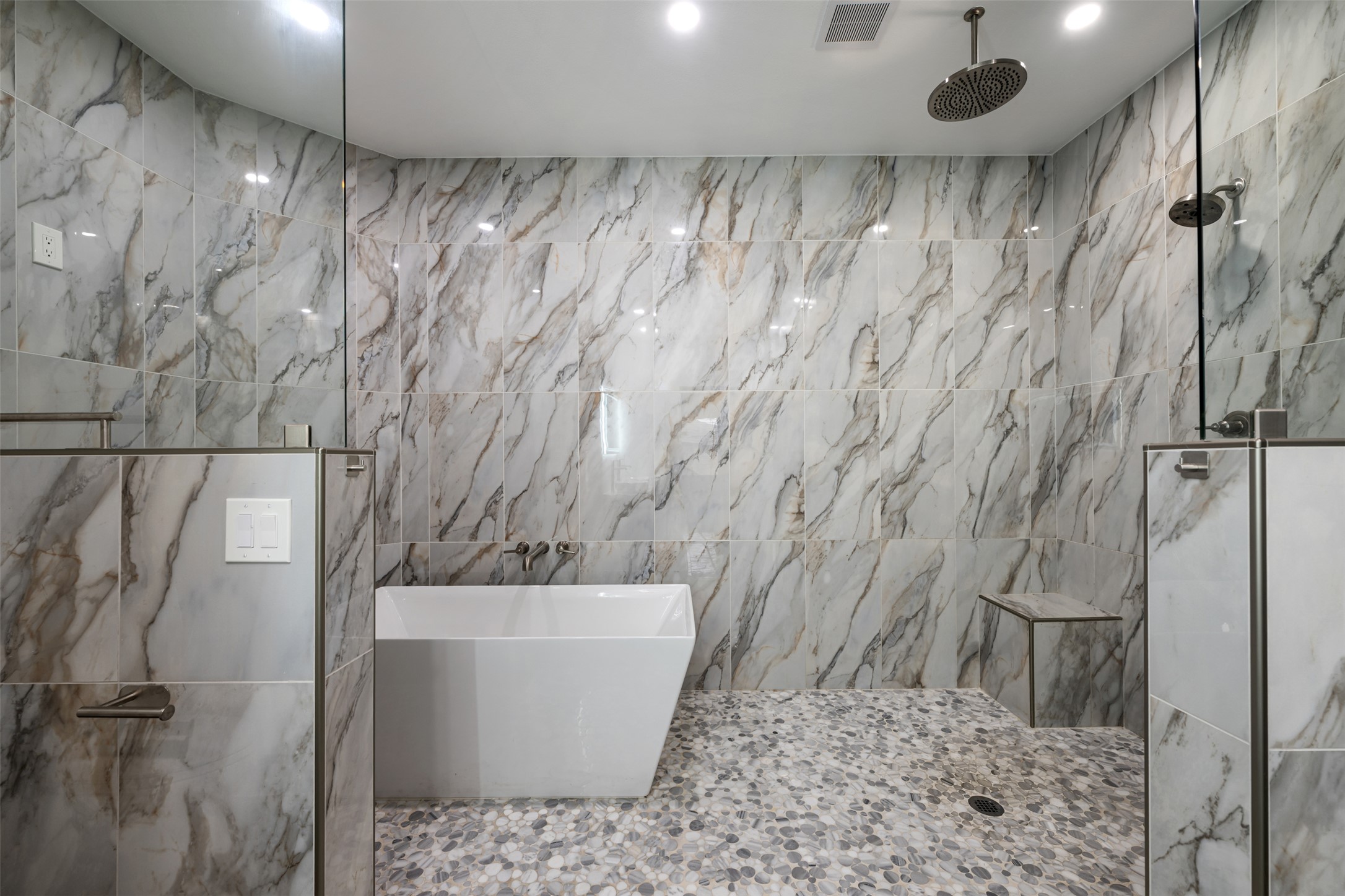 a bathroom with a bathtub and shower