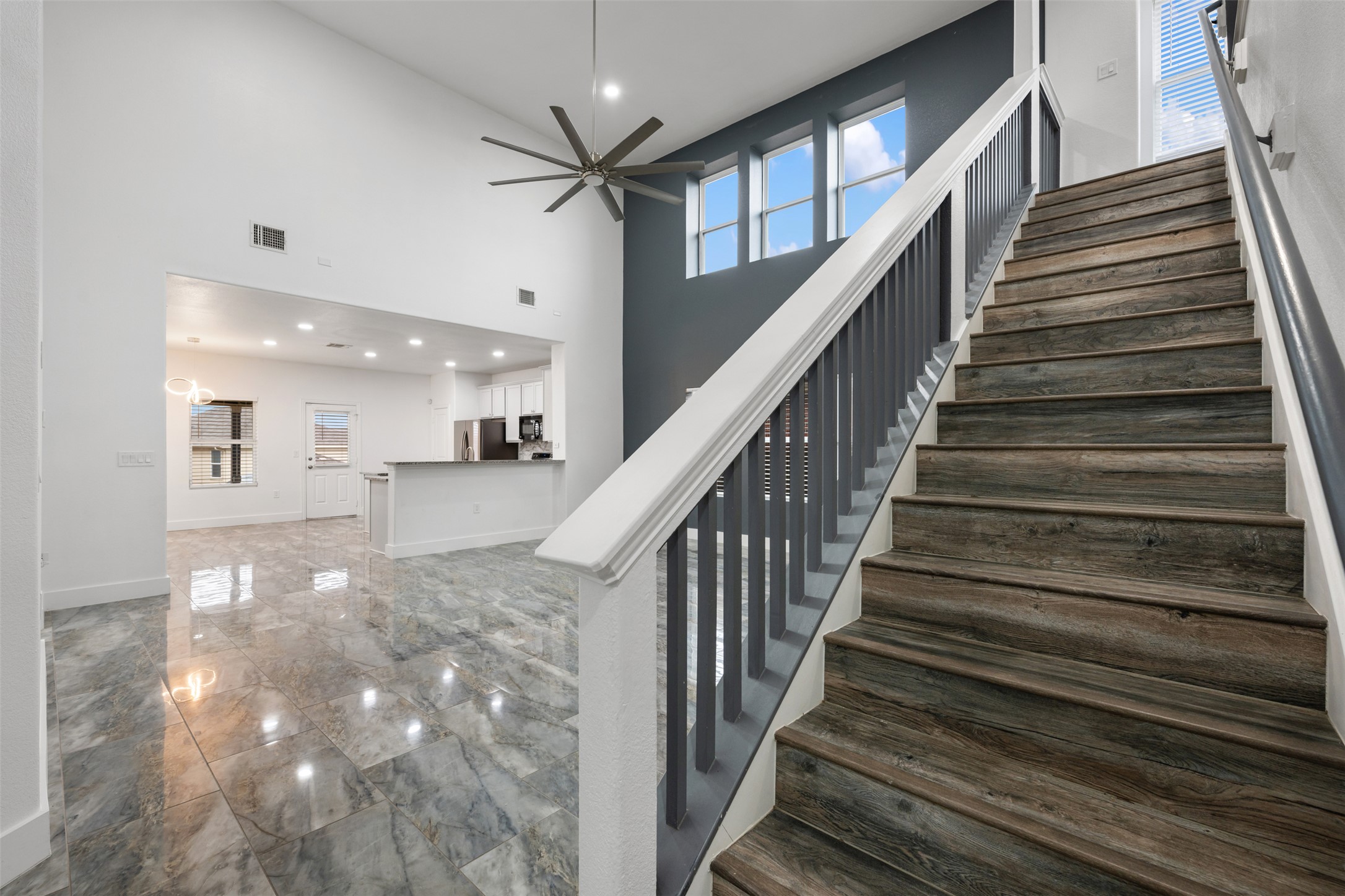 3400 Stephans Street Pflugerville, TX 78660 - Photo 11 of 40 a view of staircase with lots of frames on wall and windows