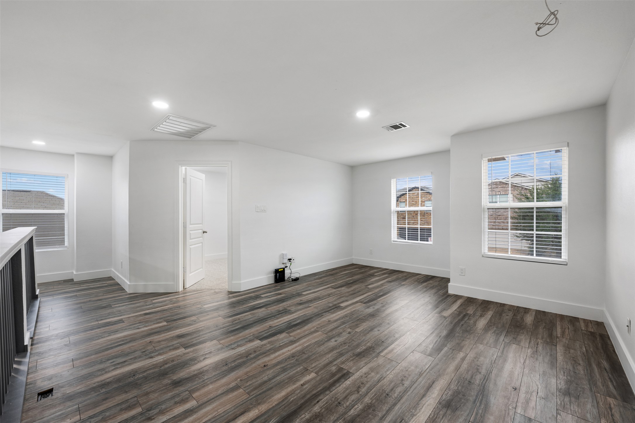 3400 Stephans Street Pflugerville, TX 78660 - Photo 30 of 40 an empty room with wooden floor and windows