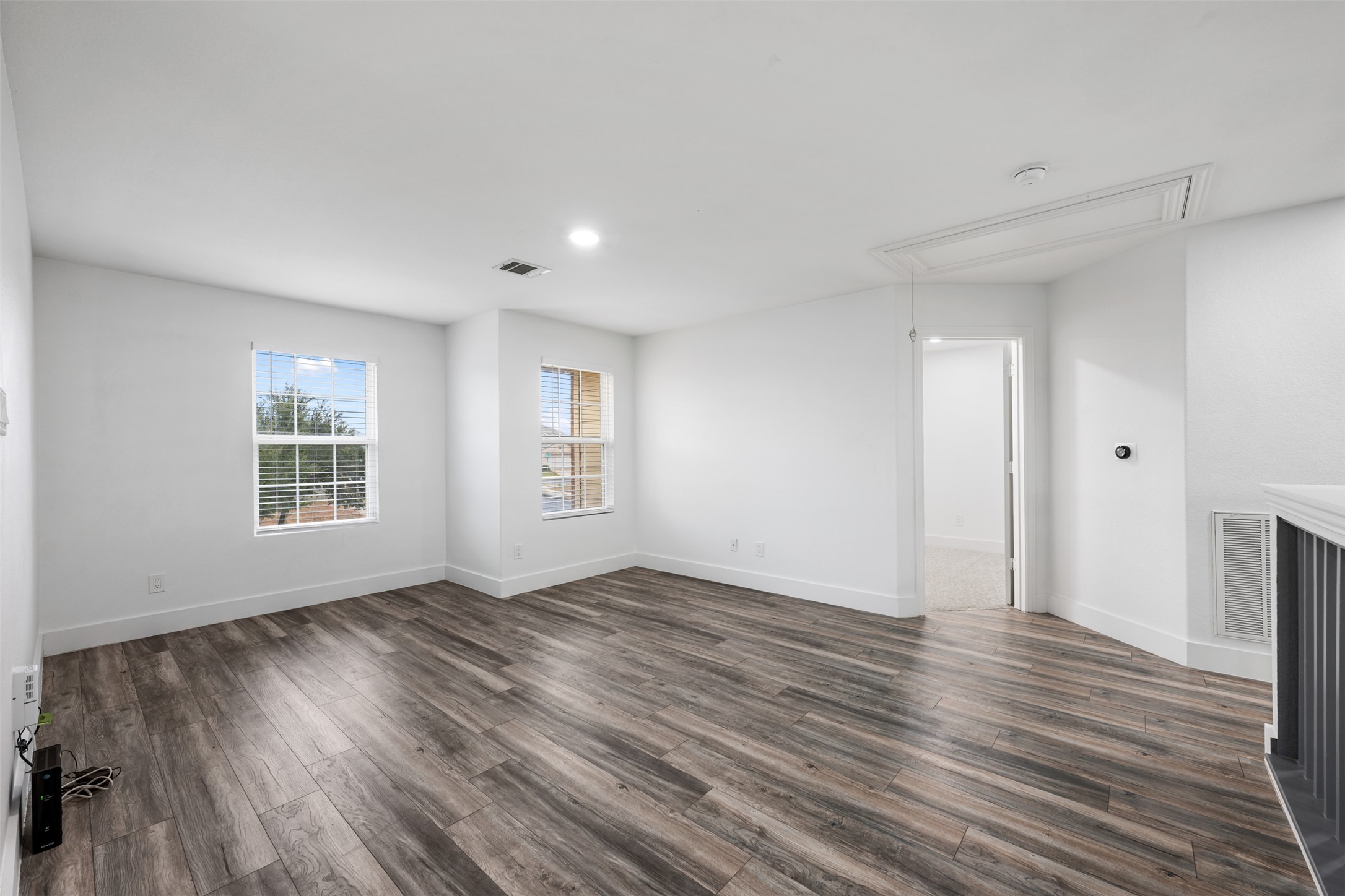3400 Stephans Street Pflugerville, TX 78660 - Photo 32 of 40 a view of an empty room with wooden floor and a window