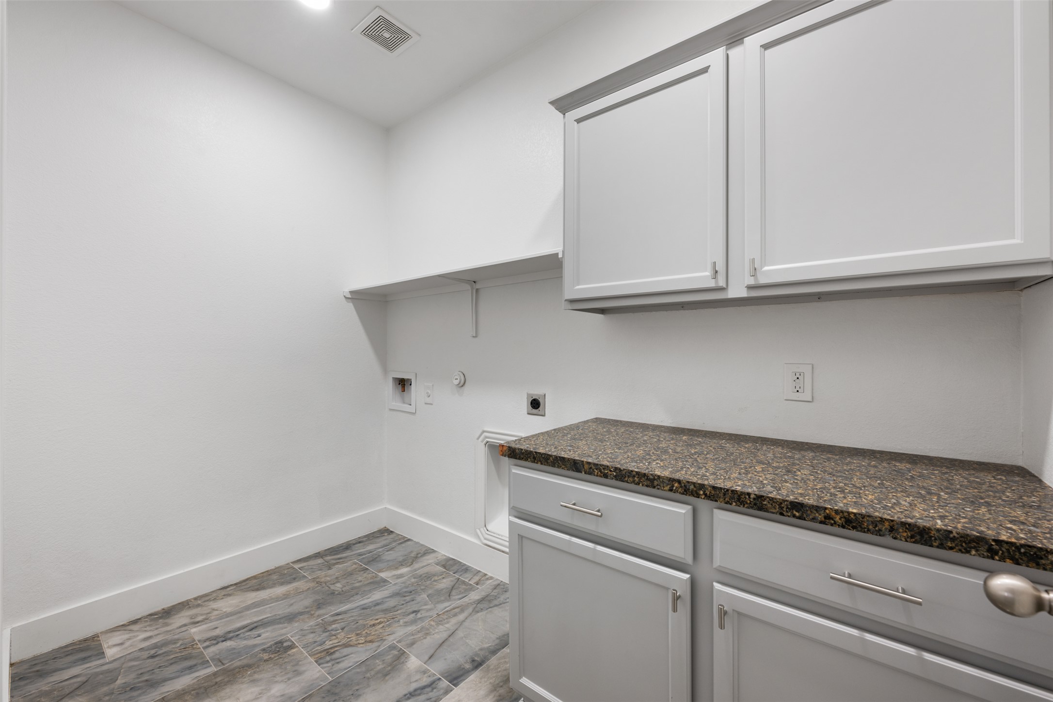 3400 Stephans Street Pflugerville, TX 78660 - Photo 9 of 40 a kitchen with granite countertop white cabinets and a sink
