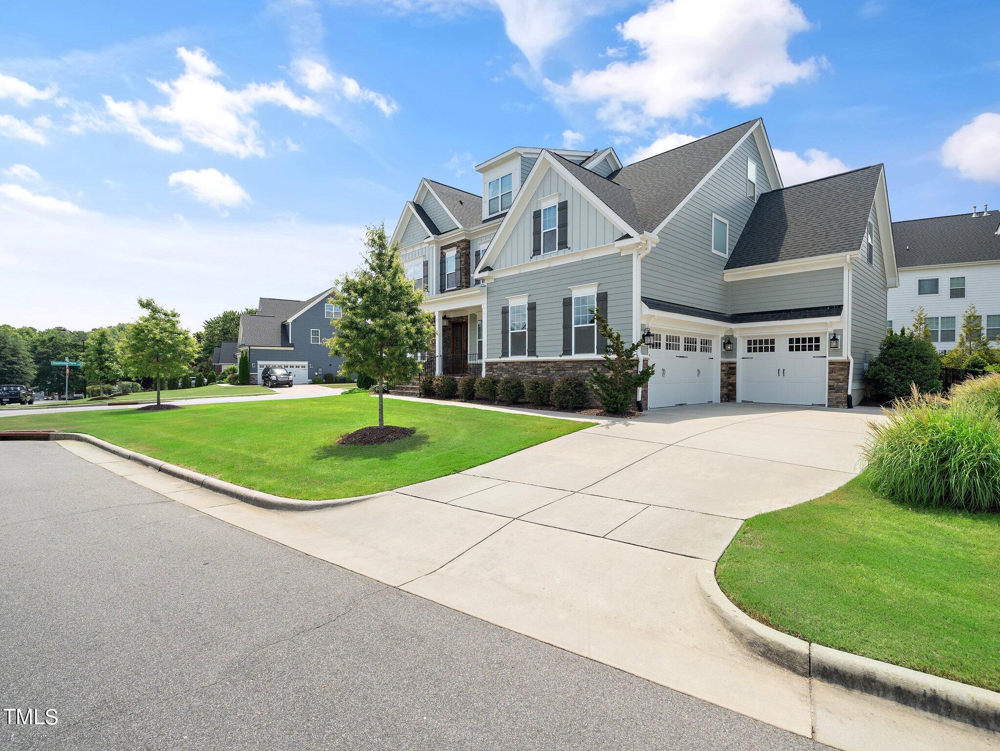 7733 Wilderness Road Raleigh, NC 27613 - Photo 2 of 37 a front view of a house with a yard