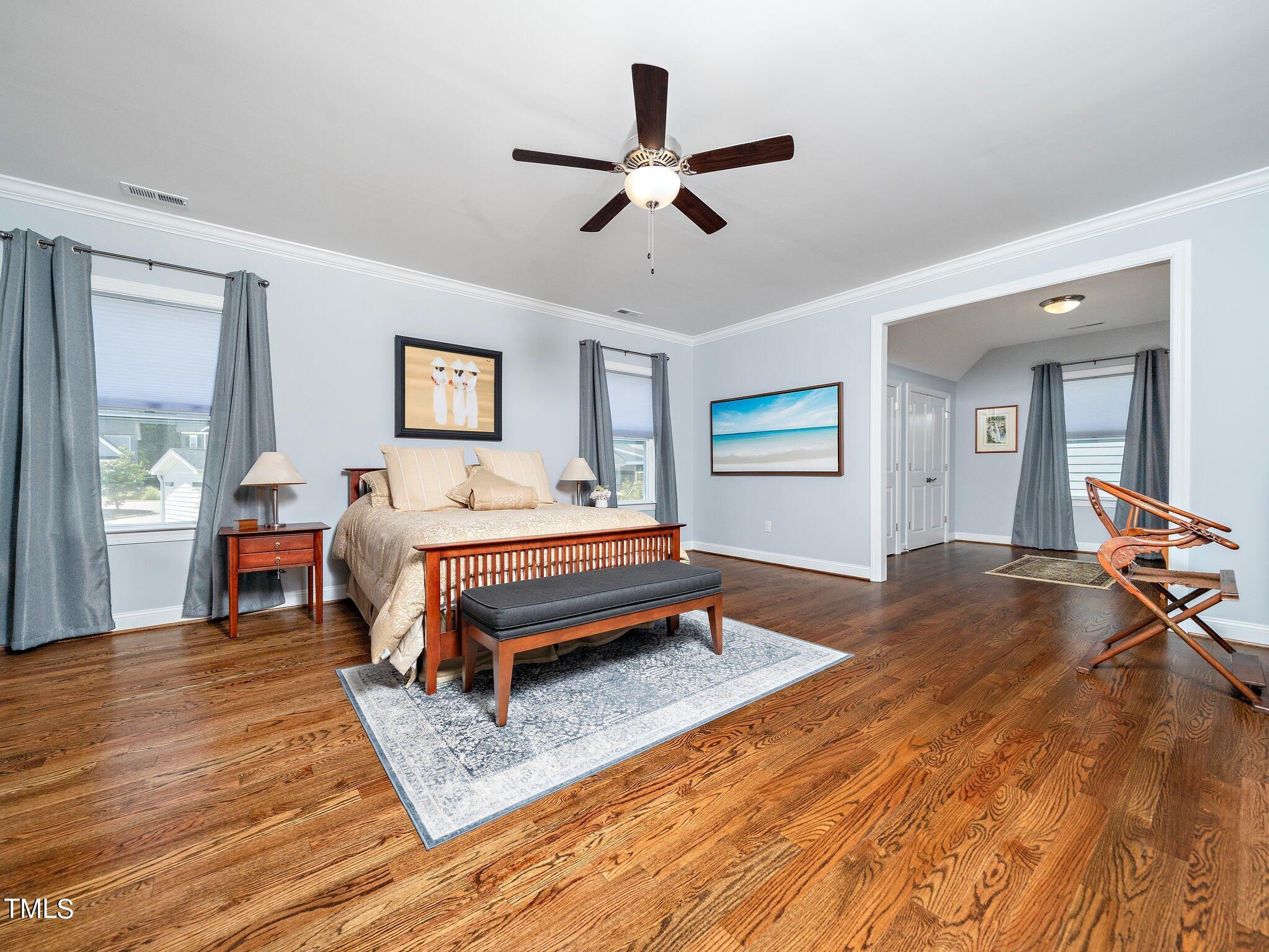 7733 Wilderness Road Raleigh, NC 27613 - Photo 22 of 37 a bedroom with a bed and dresser