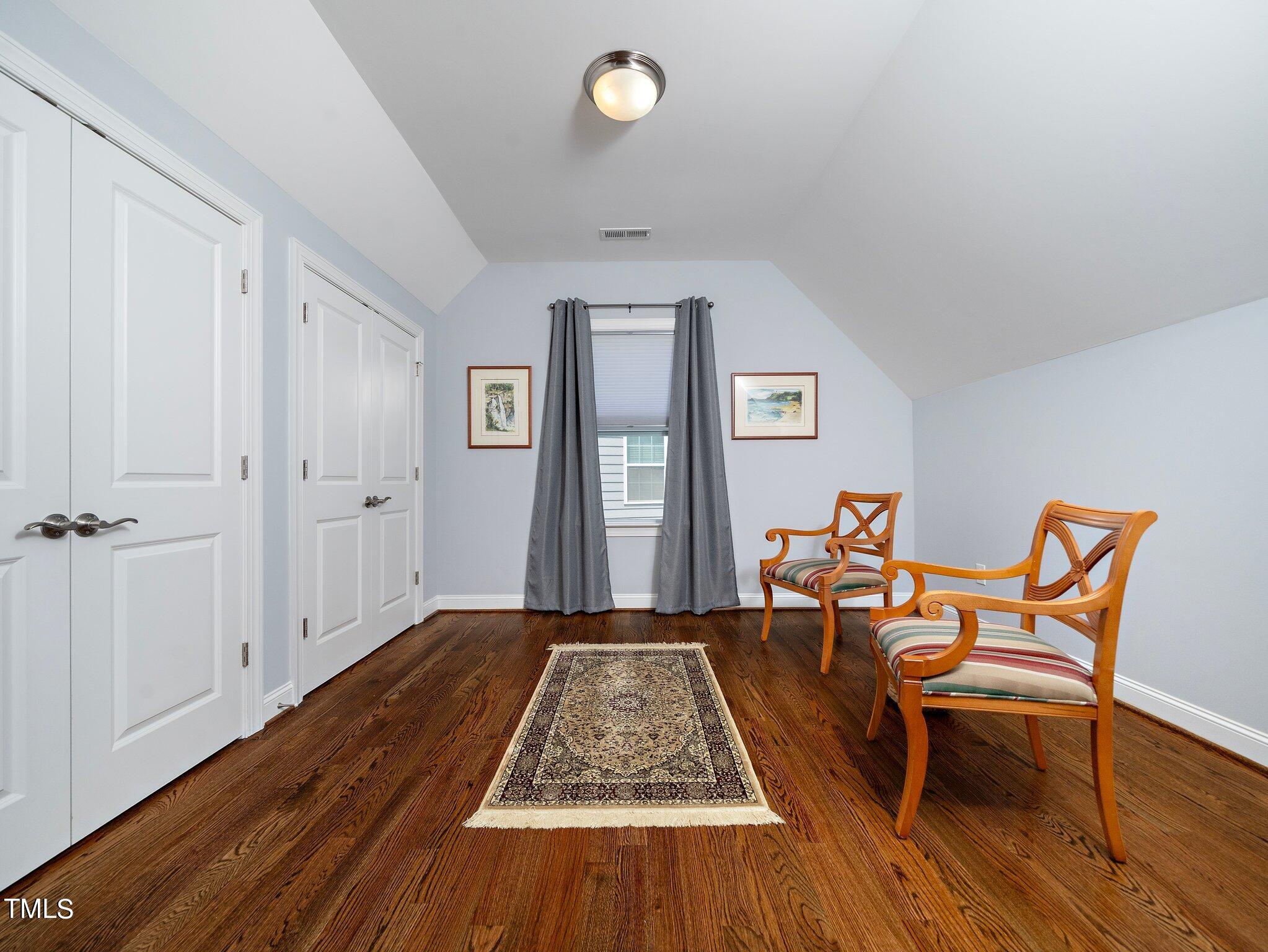 7733 Wilderness Road Raleigh, NC 27613 - Photo 23 of 37 a living room with furniture and a wooden floor