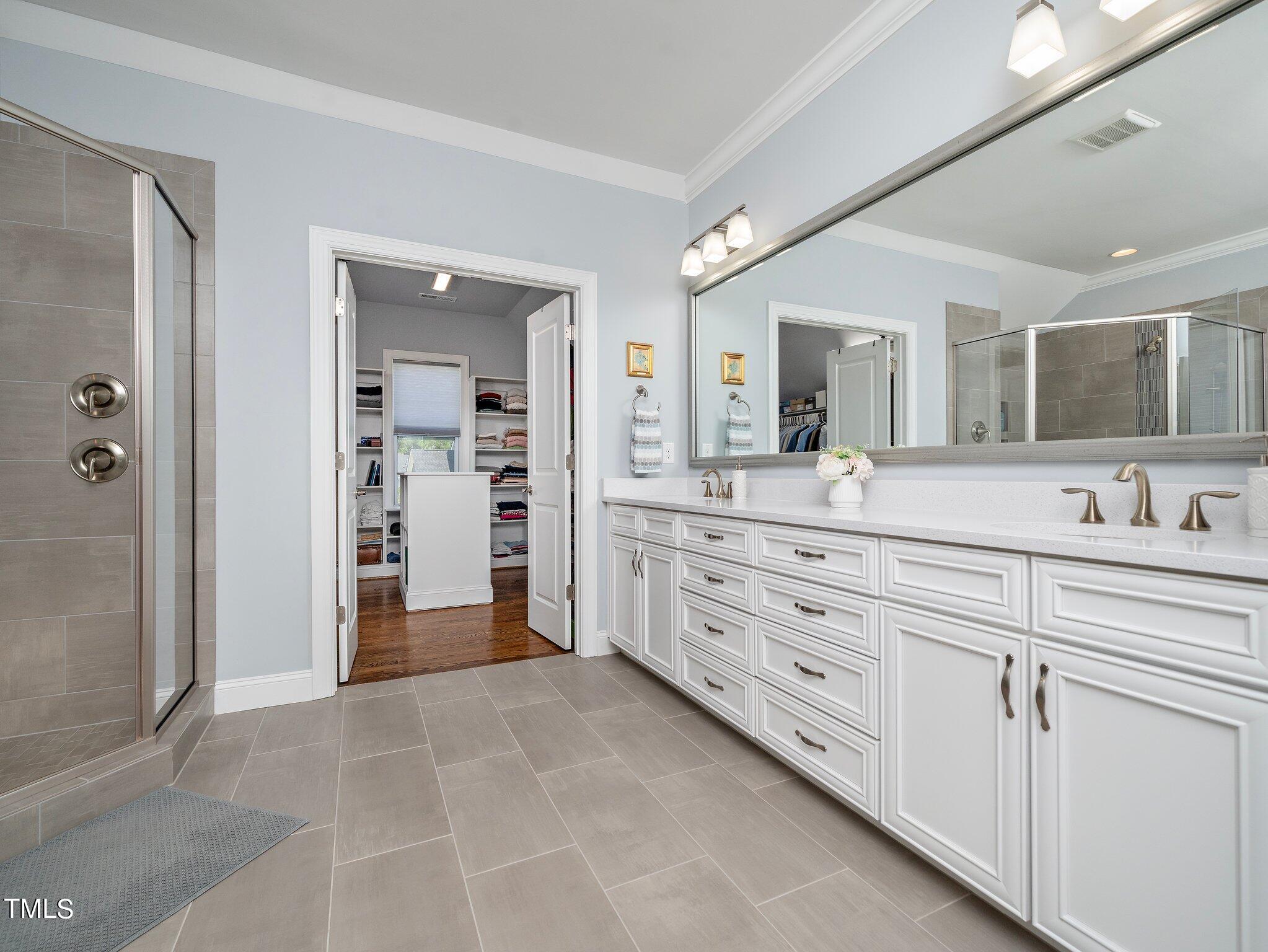 7733 Wilderness Road Raleigh, NC 27613 - Photo 24 of 37 a spacious bathroom with a granite countertop sink mirror and
