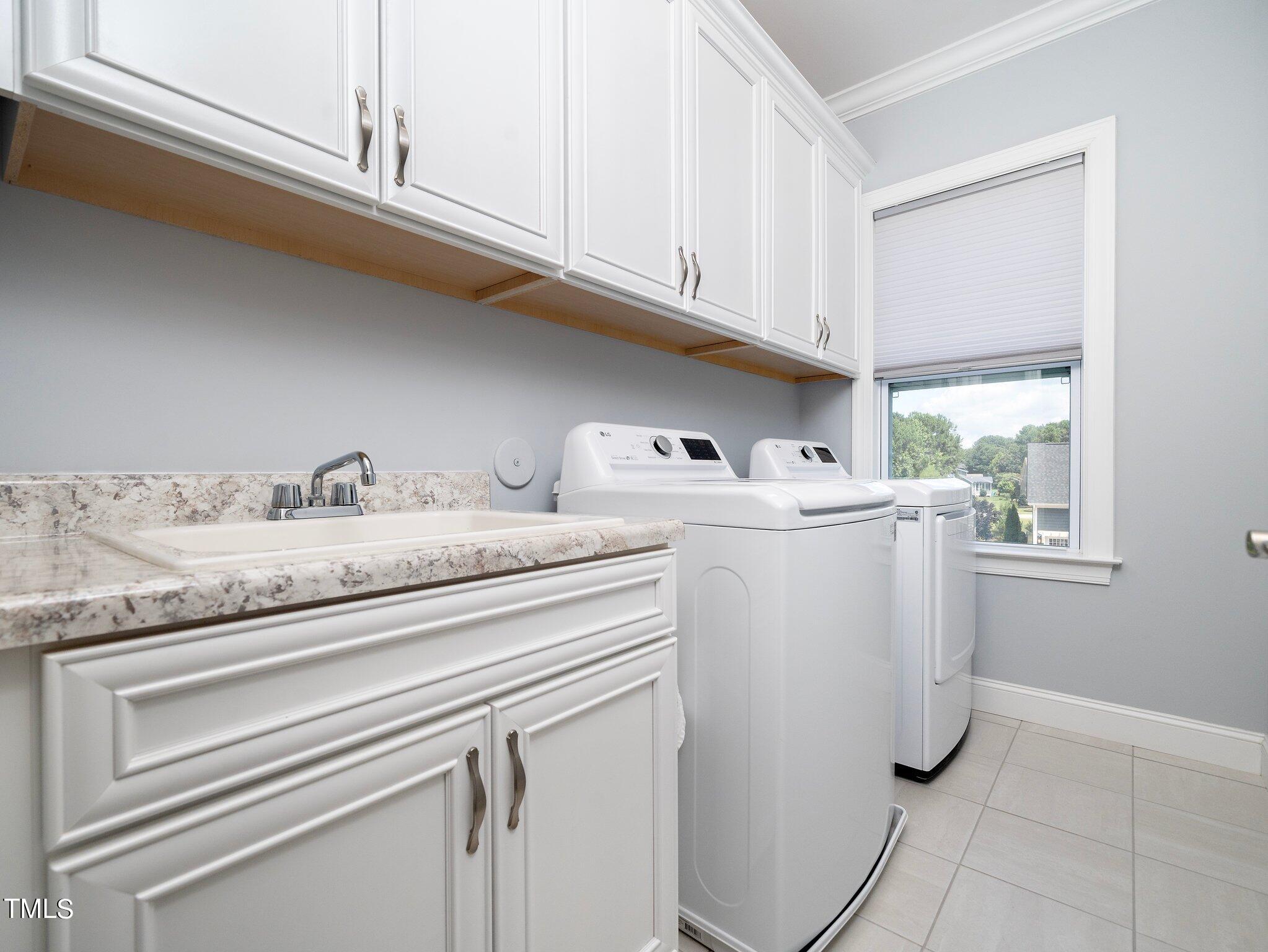 7733 Wilderness Road Raleigh, NC 27613 - Photo 27 of 37 a utility room with dryer and washer