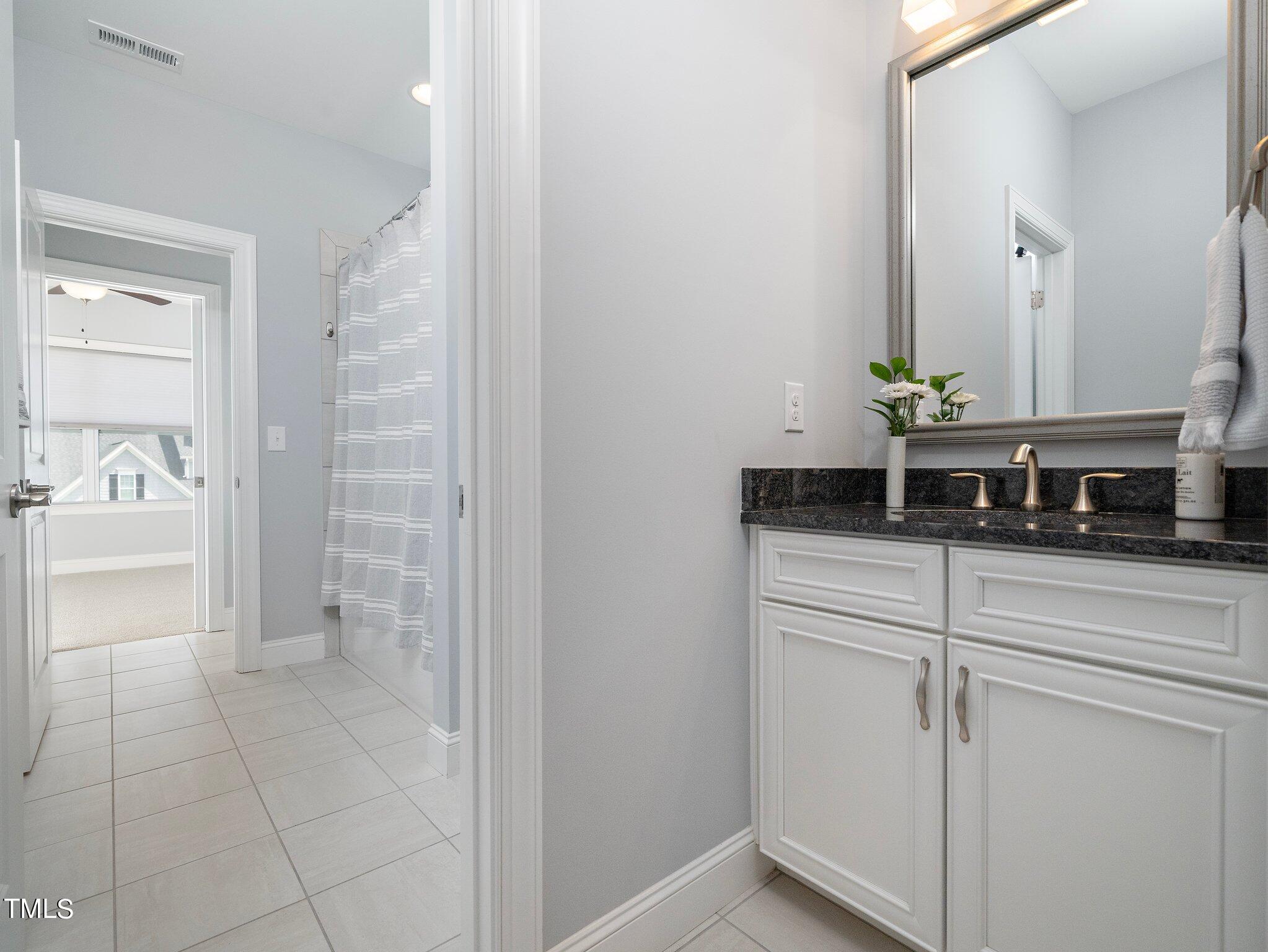 7733 Wilderness Road Raleigh, NC 27613 - Photo 29 of 37 a bathroom with a sink and a mirror