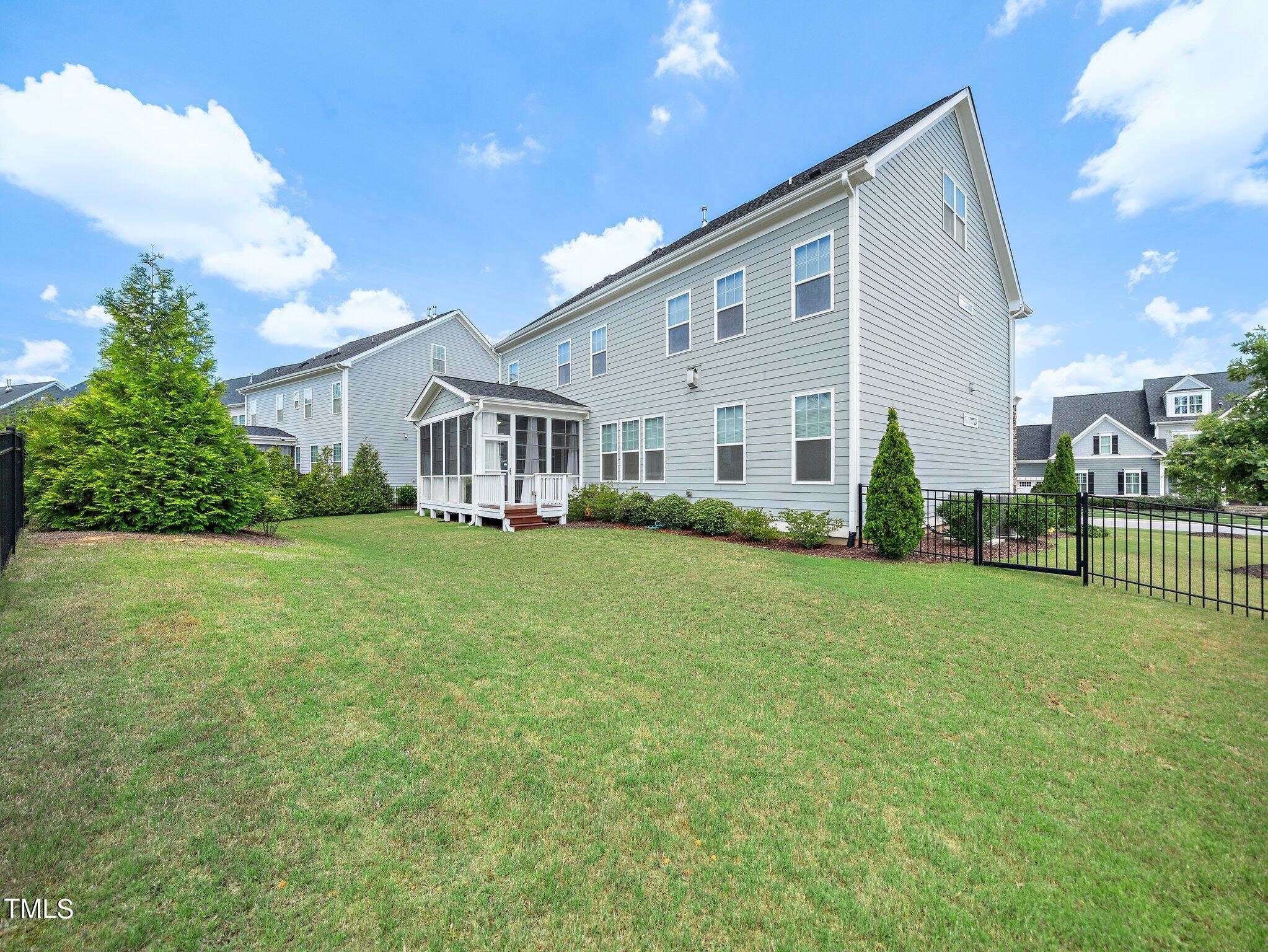 7733 Wilderness Road Raleigh, NC 27613 - Photo 33 of 37 a front view of house with yard and green space