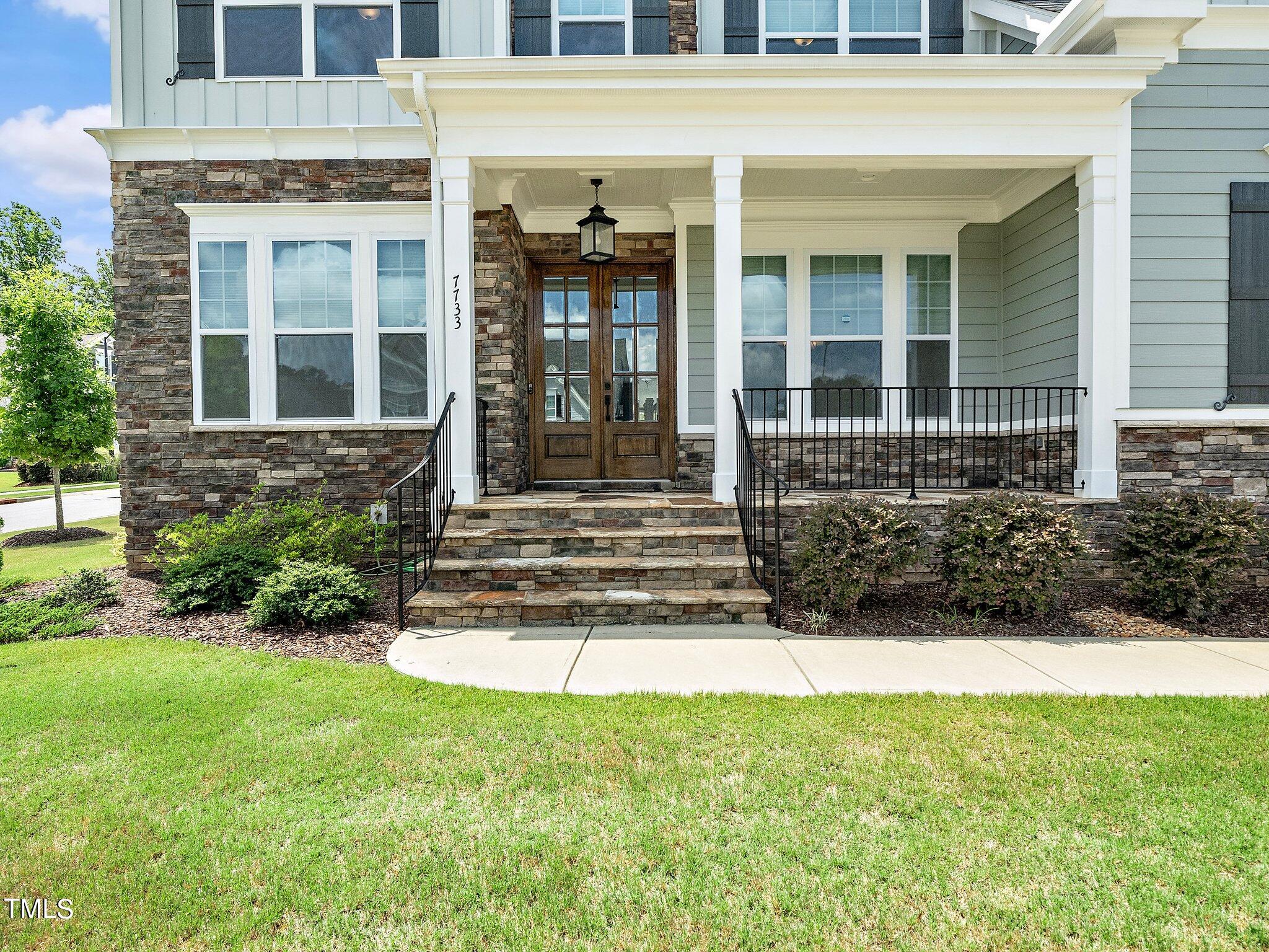 7733 Wilderness Road Raleigh, NC 27613 - Photo 4 of 37 front view of a house with a yard