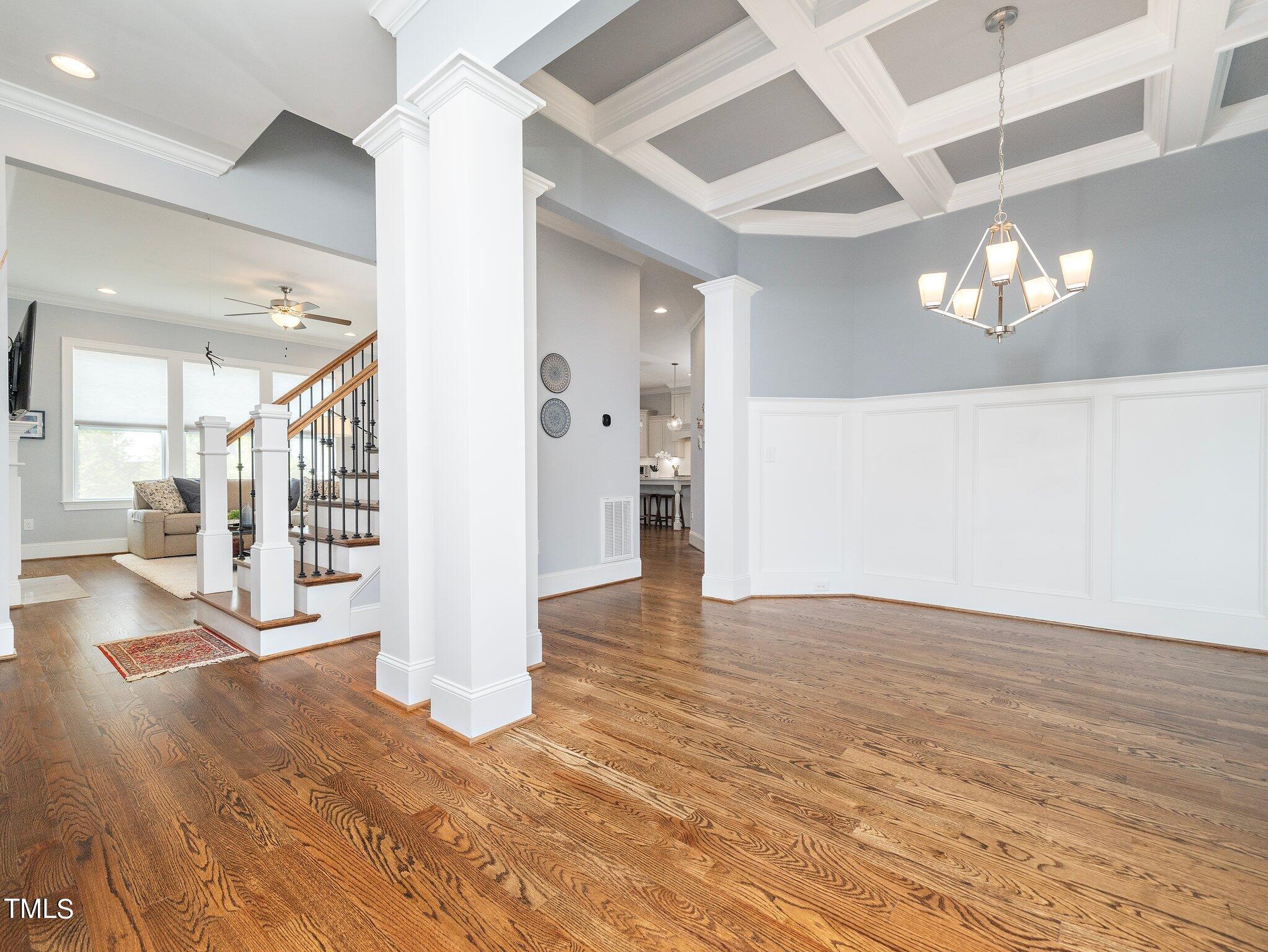 7733 Wilderness Road Raleigh, NC 27613 - Photo 6 of 37 a view of a big room with wooden floor and windows