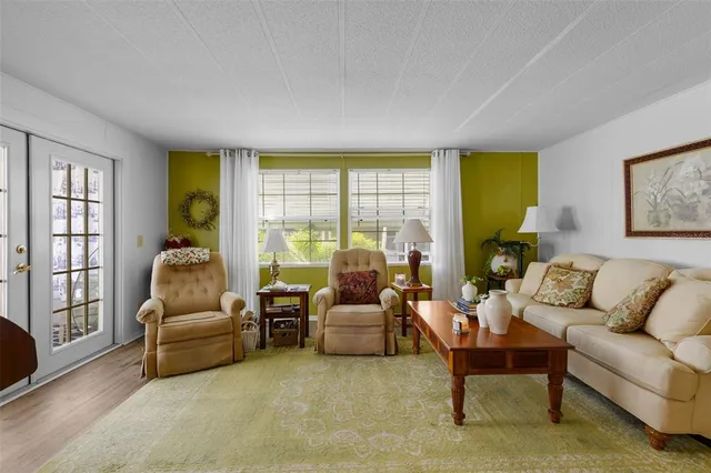 a living room with furniture and a floor to ceiling window
