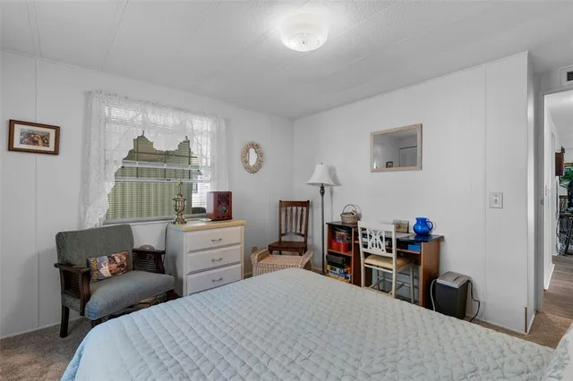 a bedroom with a bed and a desk