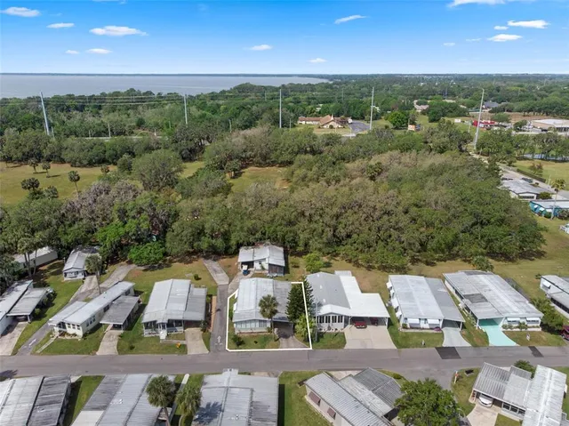 an aerial view of a houses with a lake view