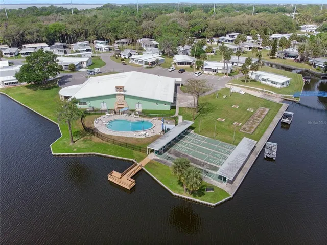 a view of a lake with a house swimming pool and outdoor space