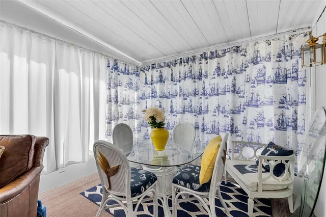 a view of a dining room with furniture and a rug